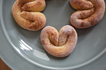 Cotage cheese homemade swirl cookies on the shining grey plate on the wooden table, geometrical ornament
