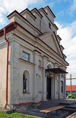 General view and architectural details of the built in 1840 together with the belfry. Classicist Catholic Church of St. Adalbert in the village of Poryte in Podlasie, Poland.