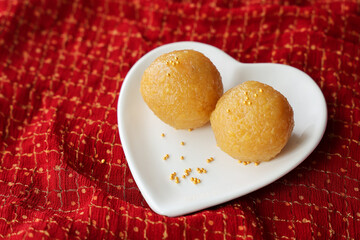 Motichoor Laddu Rava Laddu, Kesar laddoo Semolina Ladoo Indian sweet dish mithai Diwali Dussehra Holi Ram Navmi Ganesh chaturthi festival dessert snack golden plate Kerala Mumbai India Sri Lanka
