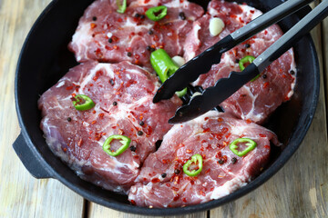 Juicy raw steaks in a pan. Delicious cooking meat.