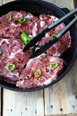 Juicy raw steaks in a pan. Delicious cooking meat.