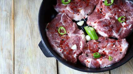 Juicy raw steaks in a pan. Delicious cooking meat.