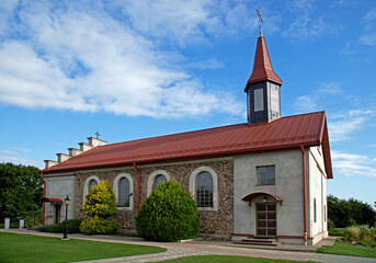 General view and architectural details of the built in 1840 together with the belfry. Classicist Catholic Church of St. Adalbert in the village of Poryte in Podlasie, Poland.