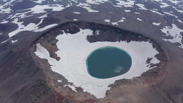 The blue lake in the crater of Gorely volcano. Kamchatka Peninsula, Russia