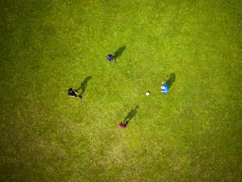 Unidentifiable children boys playing soccer on the field. Boys at football training. View from above. selective focus on figures. Top down view. Aerial view
