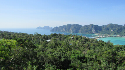 Beautiful view of trees, hills, and sea under the clear sky