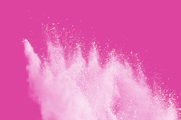 White powder explosion on pink background.