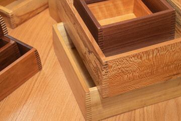 Variety of drawers stacked and waiting for hardware in a furniture workshop
