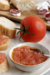Grated tomato with olive oil in bowl. Catalan typical paste to make bread with tomato (Pa amb tomaquet).