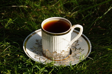 cup of tea on green grass