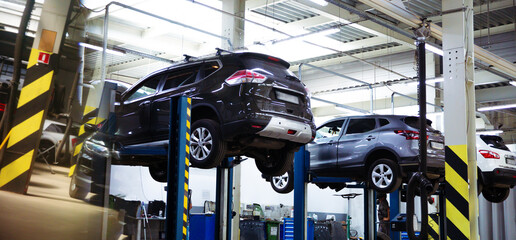 Modern car repair station with a large number of lifts and specialized equipment for diagnostics...