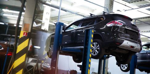 Modern car repair station with a large number of lifts and specialized equipment for diagnostics...