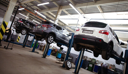 Modern car repair station with a large number of lifts and specialized equipment for diagnostics...