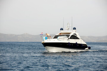 Preparing for mooring on a motor yacht. Summer vacation at the sea. Active lifestyle. Moderate...