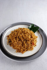 Serundeng or saur, Indonesian spicy coconut flakes, made from sauted grated coconut with spices and herbs. 