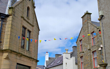 Romantic backstreet alley street in historic old town of Kirkwall, Scotland with beautiful house facades, popular travel destination on the Orkney Islands