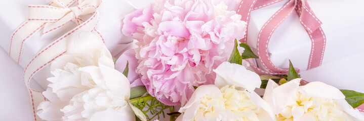 Romantic card, delicate white pink peonies flowers and gift, heart shaped ribbons. © Olga Ionina