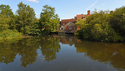 Fototapeta na wymiar Flatford Mill at Dedham Suffolk with water and trees