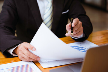 Businessman working on desk with using calculator and computer in the office. concept accounting finance, investment consultant analyzing company financial report balance statement working