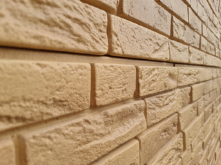 In the Imitation brick close-up. Building. Brick background. Plastic.