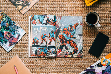 Fototapeta premium Reading comic books and manga on the carpet at cozy home. Rostov-on-Don, Russia. 22 August 2021