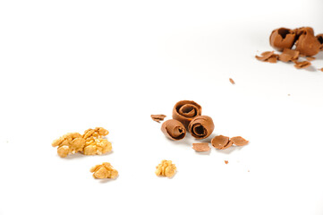 Portion of walnuts and brown chocolate shavings, isolated