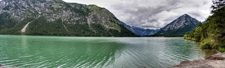 Ultra wide panorama of the Plansee in Austria in the middle of the alps. Providing a wide view and a great feeling for the size of the lake.