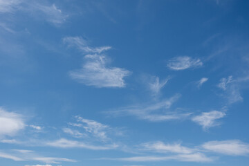 Naklejka na ściany i meble Beautiful cirrus clouds in the blue morning sky. Background of blue sky and white cirrus clouds in summer for your photos, mockup for design.