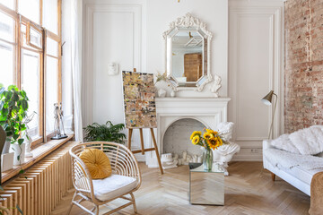 bright workshop room for the creation and work of an architect and artist in a loft style with brick walls and parquet. the walls are decorated with examples of stucco.