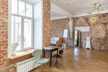 bright workshop room for the creation and work of an architect and artist in a loft style with...