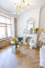 bright workshop room for the creation and work of an architect and artist in a loft style with brick walls and parquet. the walls are decorated with examples of stucco.