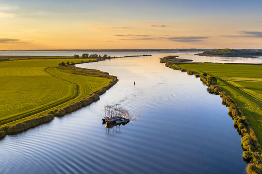 Aerial view of river with ship at sunset