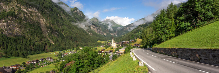 Panorama of Heiligenblut with St. Vincent Church in front of the Hohe Tauern mountains. Austria