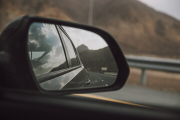 Fototapeta na wymiar Travelling View in Car Side Mirror