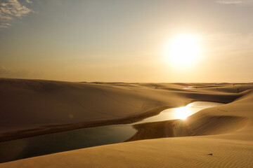 Obraz na płótnie Canvas Lencois Maranhenses national park, Brazil. Dunes and lagoons, on sunset