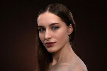 Fototapeta premium Beautiful woman face close up portrait with no make up. Healthy pure skin model isolated on black background. Natural make up concept. Spa and beautiful concept. 