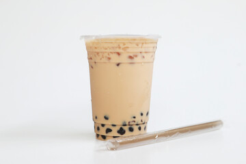 Small cup Iced milk tea Taiwan style with straw on white background, fresh cool sweet drink, food and drink concept