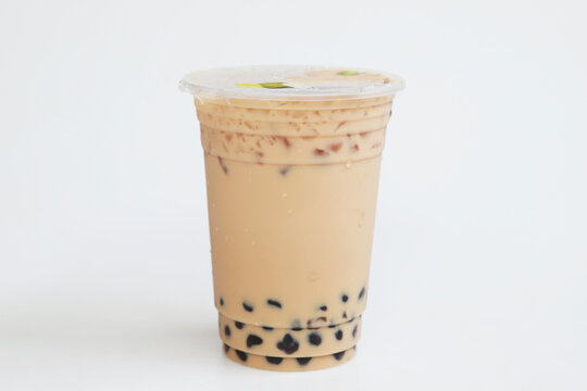 Small plastic cup Iced milk tea Taiwan style on white background, fresh cool sweet drink, Isolated fresh sweet drink, food and drink concept
