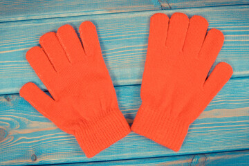 Red woolen gloves for woman on boards, clothing for autumn or winter concept