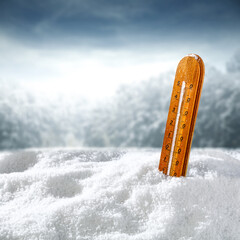 Winter background of snow and thermometer 