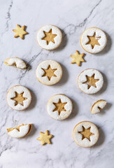 Baking background. Traditional Linzer Christmas cookies with peanut butter on a marble top. Top view flat lay background.