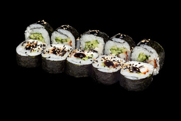 Japanese food: maki and nigiri sushi set on black background. side view composition. © Serhii