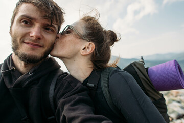 happy couple making photo on top of a mountain