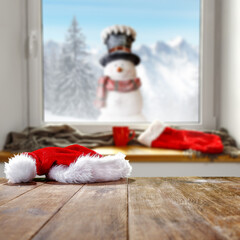 Obraz premium Winter window background and wooden desk of free space for your decoration 