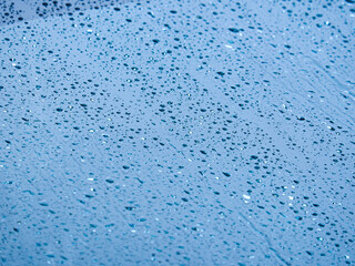 Rainwater wets the windshield. Selective focus image.