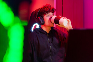 Male gamer drinking takeaway coffee