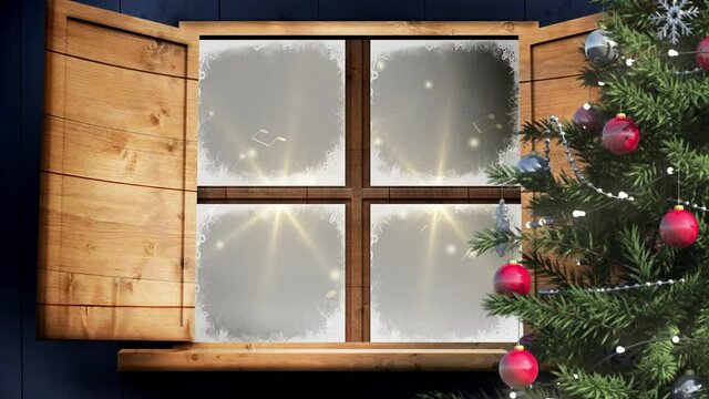 Christmas tree and wooden window frame against golden spots of light on black background