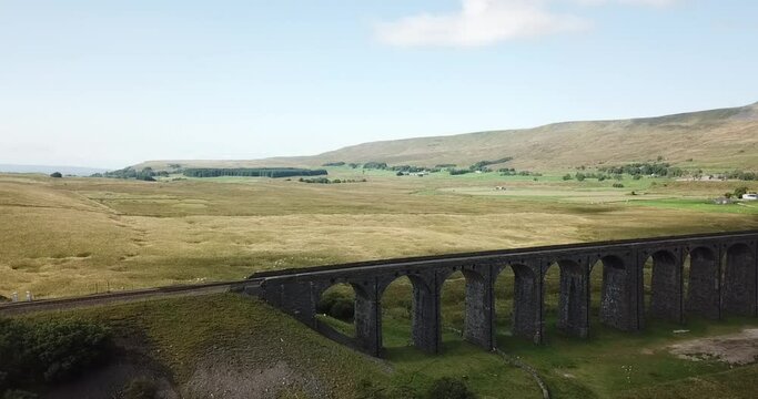 Aerial Pan along the Ribblehead Viaduct. The Viaduct is in West Yorkshire. It was opened in 1875 after a five year build across Batty Moss in the Ribble Valley