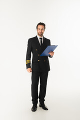 Pilot in uniform holding clipboard on white background