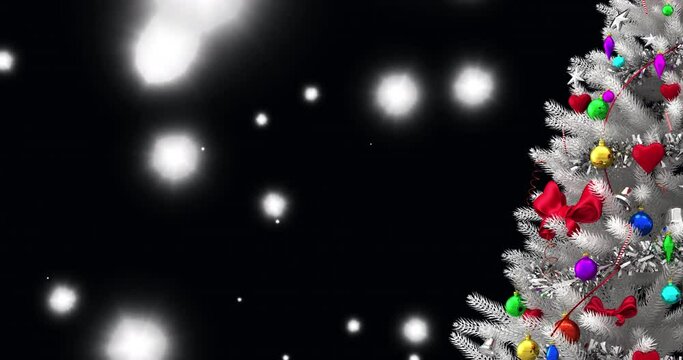 Christmas tree over white spots of light floating against black background